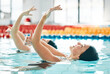 © Mumtaaz D/peopleimages.com - Synchronized, swimming and woman in competition performance, event or dance together in pool, water or sport. Athlete, swimmer and people training for concert, dancing or duet or stretching arms