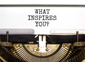 What inspires you symbol. Concept words What inspires you typed on beautiful retro old typewriter. Beautiful white background. Business motivational what inspires you concept. Copy space.