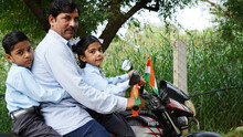 Indian Asian Father Son And Daughter Traveling On Motorcycle.