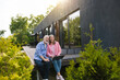 © zinkevych - Wife and husband using laptop with solar panel at home porch.