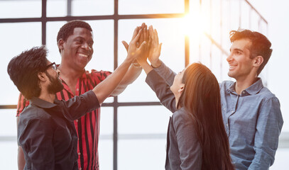 Teamwork - business people with joint hands in the office