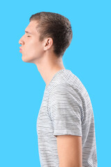 Sticker - Young man blowing kiss on blue background