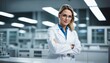 © ibreakstock - Young woman scientist in white coat and glasses with team of specialists in modern medical laboratory with copyspace