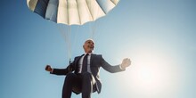 Businessman Cheers While Hanging On Parachute, Signifying Success And Safety In Big Business Ventures, Amidst A Sun-Kissed Summer Sky, Embracing Financial Triumph And Prosperity