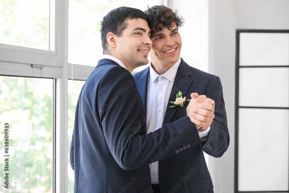 Happy gay couple dancing on their wedding day