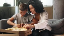 Portrait Of Adorable Little Boy Child Kid And His Young Mother Mom Eating Pizza With Great Pleasure And Enjoying Beautiful Day Together At Home Happy Childhood And Cute Family Concept