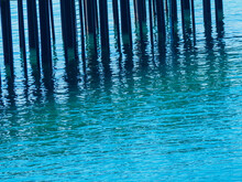 Pier Pilings Casting Reflections On Blé Seawater, Eureka California