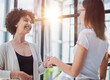 © Katsiaryna - Two Businesswomen Shaking Hands In Modern Office