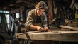 © PaulShlykov - Young Carpenter happy working to making woodcraft furniture in wood workshop look professional high skill.
