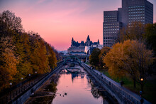 Fall Foliage Around The Rideau Canal, With The Exterior Of The Landmark Hotel Fairmont Chateau Laurier And Pink Sunset Sky. Autumn View Of Downtown Ottawa, Ontario, Canada, November 2021.