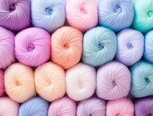 Many Balls Of Woolen Yarn In Pastel Shades. Background In Soft Pastel Shades. Knitting And Crochet.