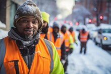 Portrait Of A Smiling Middle Aged African American Sanitation Worker Working In Sanitation In The City During The Winter And Snow