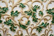 decorative pattern on a whitewall with gold and green ornamentation