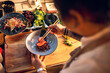 © Marko Geber - Male asian chef preparing a traditional food dish in a restaurant kitchen