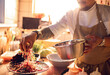 © Marko Geber - Male asian chef preparing a traditional food dish in a restaurant kitchen