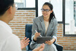 © ijeab - Happy hiring manager interviewing a job candidate in her office