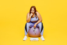 Full Body Young Chubby Plus Size Big Fat Fit Woman Wear Blue Top Warm Up Training Sit On Fit Ball Near Scales Measure Tape Isolated On Plain Yellow Background Studio Home Gym. Workout Sport Concept.