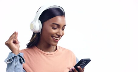 Poster - Woman, headphones and phone in studio, dancing and listening to music, sound and happy by white background. Girl dancer, smartphone and excited smile for audio streaming, subscription and web app