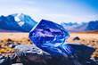 Atop a snow-capped mountain, a tanzanite reflects the vivid azure of the sky, merging earth and heavens