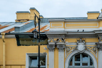 Vintage lanterns on a pole against the background of the building.