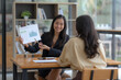 © amnaj - Two Asian businesswomen are consulting on marketing planning, a new corporate sales strategy in line with current events.
