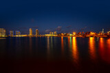 Fototapeta  - Miami city skyline panorama at night skyscrapers and bridge over sea with reflection