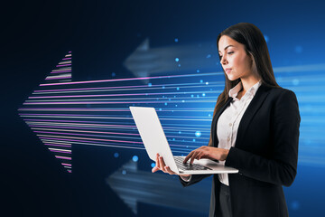 Poster - Side view of attractive young european businesswoman using laptop with glowing digital arrow made up of blue tech lines on dark background. Market, technology and top concept.