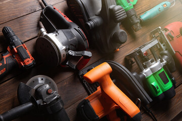 Set of electric tools on the wooden table. Various power tools for renovation and construction