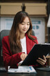 © NINENII - businesswoman working at office with laptop and documents on his desk, financial adviser analyzing data.
