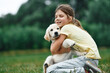© standret - On the ground. Cute little girl is with golden retriever dog on the field