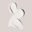 cosmetic product smears of cream on beige background, lotion white smudge, moisturizer swatches liquid texture
