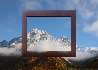 Wall Mural - Wooden frame and beautiful mountains with fog in morning