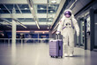 Astronaut in space suit with purple travel suitcase goes on a plane flight at the airport, space man goes on a journey