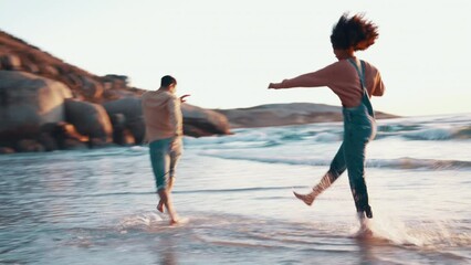 Poster - Couple, running and water splash at beach, playful and comic game with freedom, adventure and holiday. Young man, woman and outdoor for bonding, love and vacation with waves, ocean or summer sunset