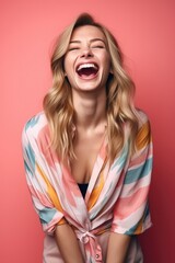 Wall Mural - studio shot of a cheerful young woman posing against a colorful background