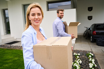 Wall Mural - Wife and husband carry boxes with things to a new house