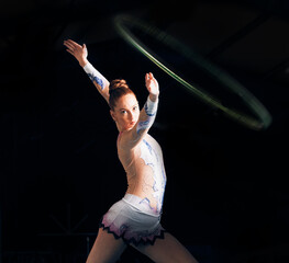 Sticker - Fitness, energy with a gymnastics hoop and a woman in the gym for a performance showcase or practice. Dance, training and concert with a female athlete on a dark background for routine or recital