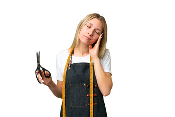 Poster - Young blonde Seamstress woman over isolated chroma key background with headache