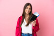 © luismolinero - Young caucasian woman isolated on pink background happy in vacation with passport and plane tickets