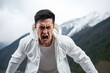 Anger Asian Man In White Hoodie On Mountain Scenery Background. Сoncept Anger Management, Asian American Representation, Outdoor Adventure, Hoodies Style Choices