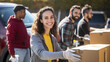 © MP Studio - Volunteer holding a box of various aid for charity