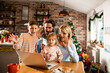 © Geber86 - Young family having a video call on their laptop during christmas and the new year holidays