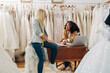 © cherryandbees - Two women enjoy working together in a bridal salon.