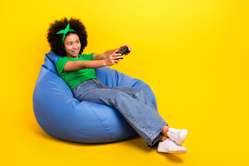 Wall Mural - Full length profile photo of excited funky girl hold controller play video games empty space isolated on yellow color background