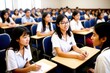 © useful pictures - Lecture Concept. Group of interested multicultural mixed race group of students sitting at tables with pc in modern classroom, listening to teacher, taking notes writing in notebooks, back to study