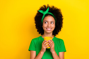 Canvas Print - Photo of creative minded teenager schoolgirl arms hold cacao mug look empty space isolated on yellow color background