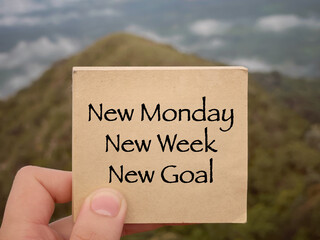 Wall Mural - Motivational and inspirational wording. New Monday, New Week, New Goal written on a notepad. With blurred styled background.