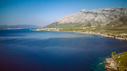 Canvas Print - St. Elijah mountain rising high above town of Orebic on Peljesac peninsula, overlooking island of Korcula in the distance, photographed with drone