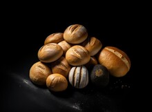 Different Kind Of Natural Breads. Fresh Loafs Of Bread In The Blue Basket With Ears Of Rye And Wheat On A Black Background. Crunchy French Baguettes. Soft Focus Style, Closeup,
