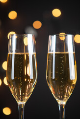 Two glasses of sparkling wine or champagne with bokeh background